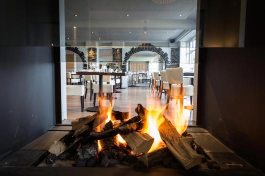 A view of the restaurant at Sandy Cove Hotel through the fireplace