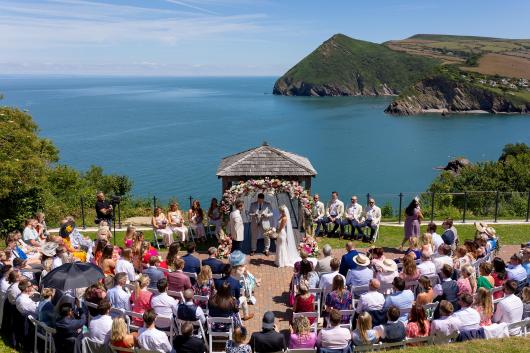 A wedding party gathered around the Gazebo at The Venue, Sandy Cove Hotel