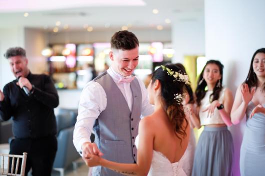 A bride and groom sharing their first dance on their wedding day at The Venue, Sandy Cove Hotel