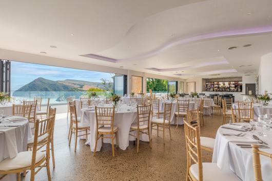 Inside The Venue at Sandy Cove Hotel with tables set up for a wedding reception