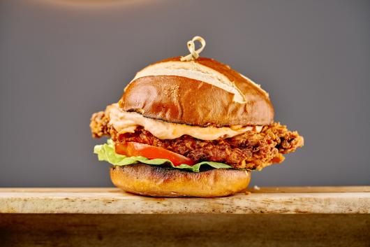 A spiced fried butterfly chicken burger in The Cove Restaurant at Sandy Cove Hotel