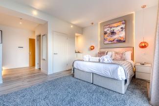 The interior of a luxury sea view room with balcony at Sandy Cove hotel