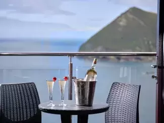Flutes of champagne on the balcony of a classic sea view with balcony room at Sandy Cove Hotel