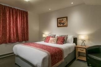 A bed inside a standard room at Sandy Cove Hotel